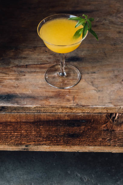 istock orange cocktail in coupe glass with herb garnish 1363897569