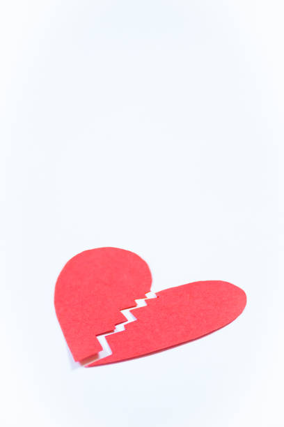 Vertical close-up of broken heart on light background with copy space