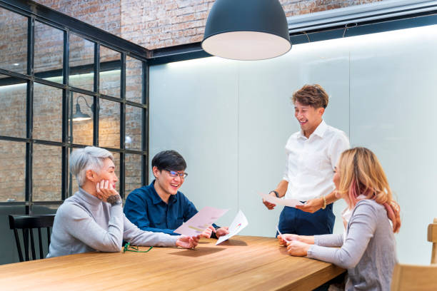 istock Team of Asian people with different age group brainstorming on data and information analysis for strategy management with young male leader for education and business concept 1363901078