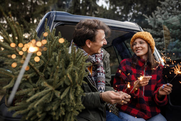 istock Young couple with sparklers and new Christmas tree 1363903998