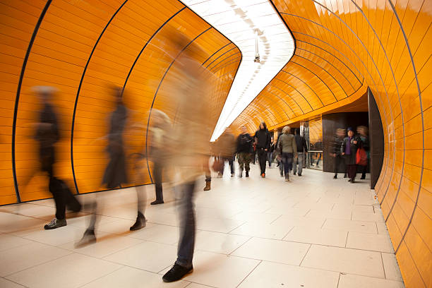 People passing by on modern orange subway stock photo