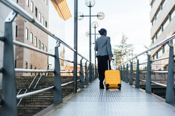 istock woman on her back with yellow suitcase 1363904893