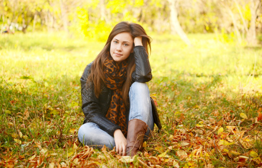 sitting woman in an autumn park