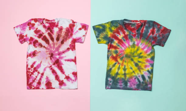 istock Neatly stacked two tie dye T-shirts on a pink and blue background. Flat lay. 1363917095