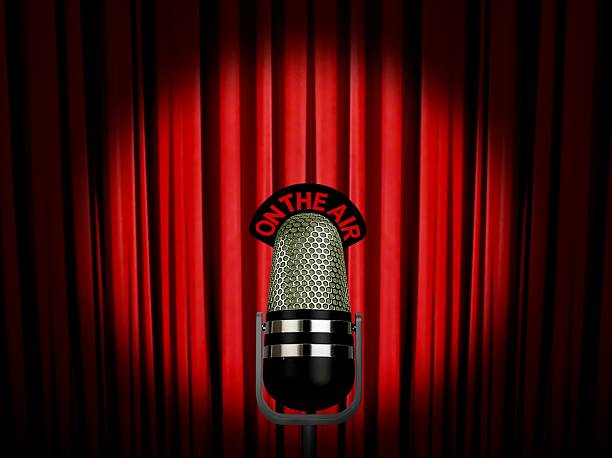 istock vintage microphone on air over red curtain 136391827