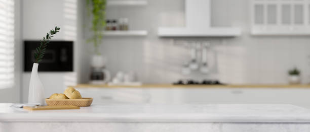 istock Marble kitchen countertop over modern white kitchen room background. 1363928117