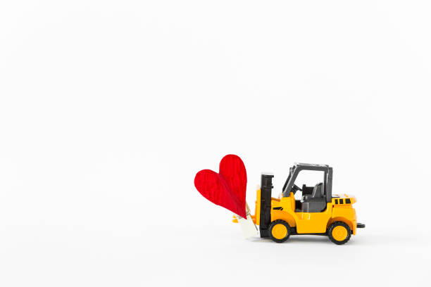 Forklift truck with red heart isolate on white background