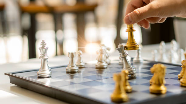 istock Businessman moving chess pieces on chess board game concept for competition and strategy. business success concept, business competition planning 1363931530