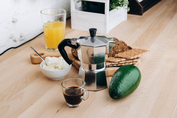 istock Breakfast food avocado soft cheese green cucumber egg , multigrain bread and crisp bread. making avocado toast or sandwich. cup of espresso coffee and moka pot. 1363937060