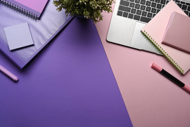 istock Creative designer workspace with laptop computer, houseplant and stationery on purple background. 1363939987