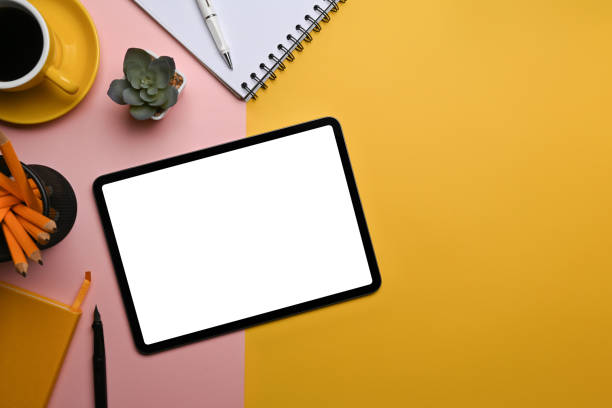 istock Mockup digital tablet with white screen and supplies on colorful background. 1363940013