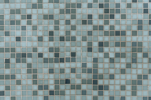 Blue mosaic tiles for bathroom or swimming pool. Ceramic square decorative tiles in different shades of blue and green. Abstract texture background. Easily add depth to your designs.