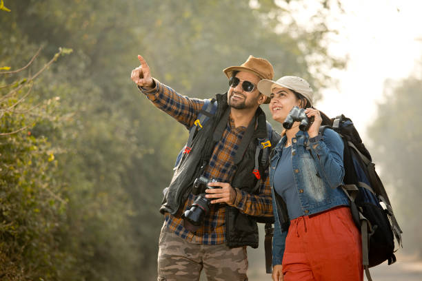 istock Couple with backpack hiking and admiring view in forest 1363943863