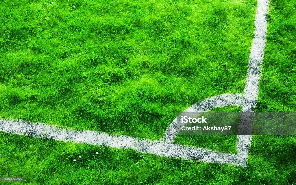 Lush Green Football Field This is actually a zoom in of a corner of a football field. It looks a bit like an white arc on a lush green background. Geometric Shape Stock Photo