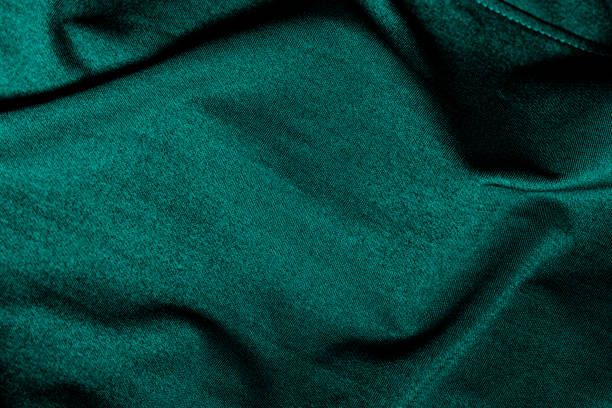 istock Folded dark cyan fabric cloth with shallow depth of field for background 1363950189