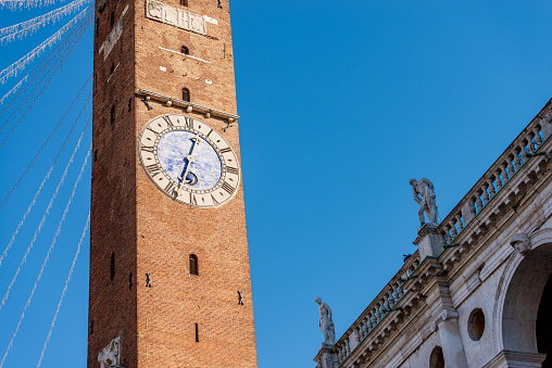 Vicenza, Basilica Palladiana, Architect Andrea Palladio in Renaissance style (1549-1614) and the ancient Civic Tower or Clock Tower called Torre Bissara or Torre di Piazza, XII century, Piazza dei Signori, Veneto, Italy, Europe.