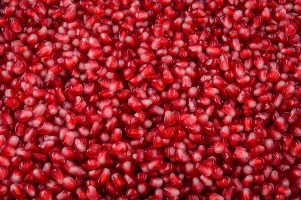 Pomegranate background. Pomegranate seeds top view. Pomegranate seeds macro flat design.