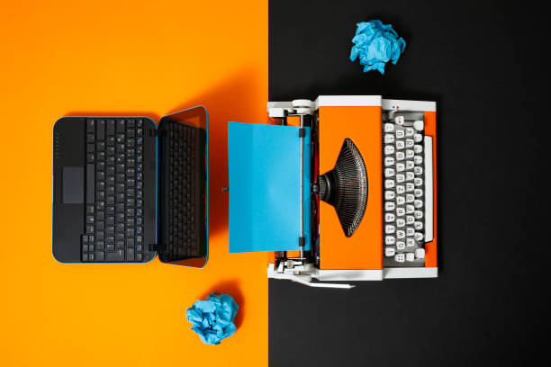 istock Digital and analog – Laptop and 70s Typewriter 1363954622