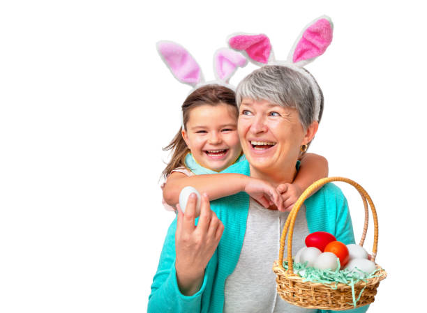 Grandmother and child in bunny ears with easter eggs isolated Portrait of grandmother and child in easter bunny ears with eggs isolated on white background traditional thai costume stock pictures, royalty-free photos & images