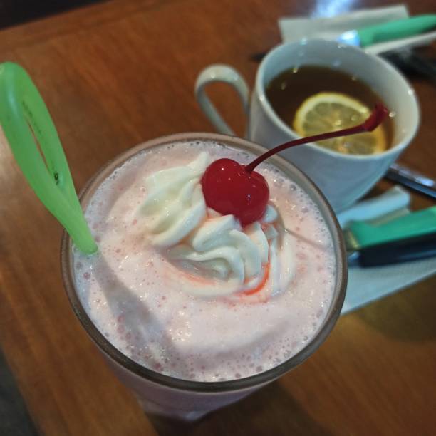 istock Strawberry milkshake next to hot lemon tea 1363959670