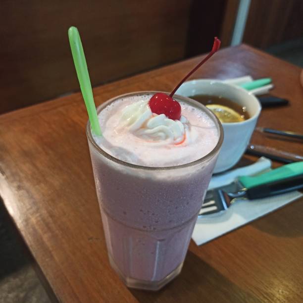 istock Strawberry milkshake next to hot lemon tea 1363959675
