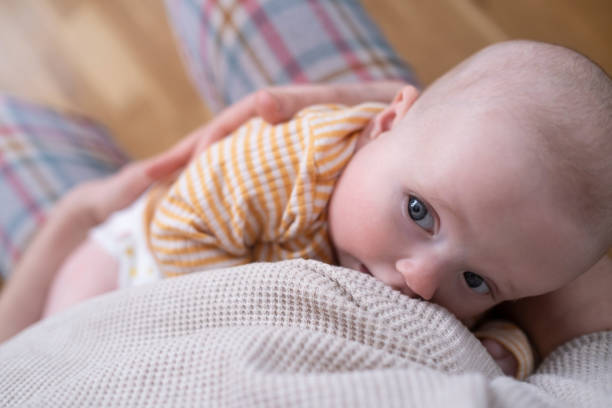 istock Funny caucasian baby lying on the bed. 1363961108