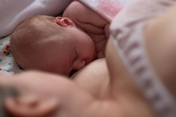 istock Baby sleeping together with her mother in bed. 1363961437