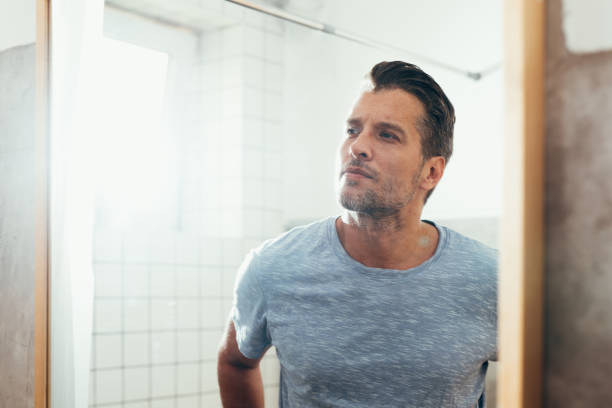 istock White Man Checking Himself Out in a Bathroom Mirror 1363961638