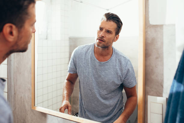 istock White Man Checking Himself Out in a Bathroom Mirror 1363961649