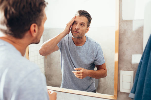 istock White Man Checking Himself Out in a Bathroom Mirror 1363961654