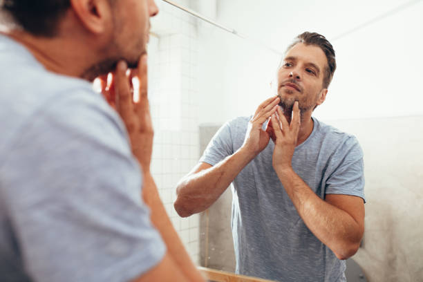 istock White Man Checking Himself Out in a Bathroom Mirror 1363961659