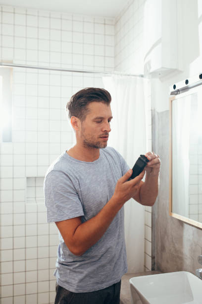 istock White Man Shaving His Beard With an Electric Shaver 1363961665