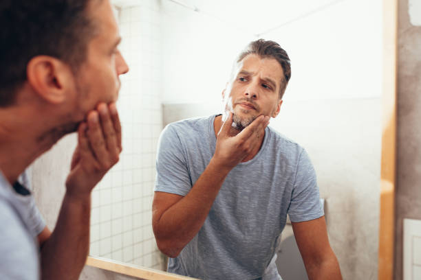 istock White Man Checking Himself Out in a Bathroom Mirror 1363961666