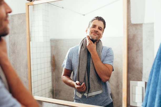 istock White Man Checking Himself Out in a Bathroom Mirror 1363961668