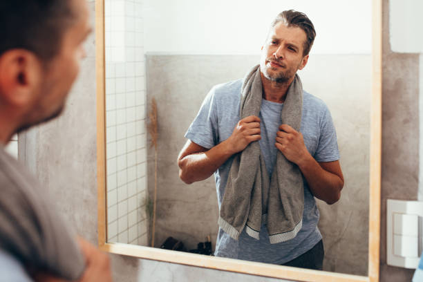 istock White Man Checking Himself Out in a Bathroom Mirror 1363961670
