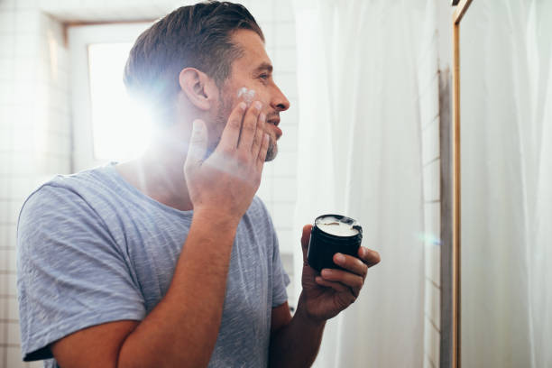istock Handsome White Man Applying Face Cream 1363961688