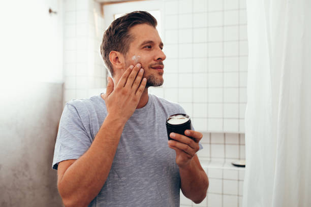 istock Handsome White Man Applying Face Cream 1363961689