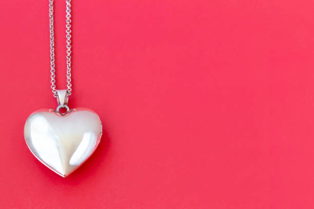 istock Heart pendant on a chain on a red background 1363962373