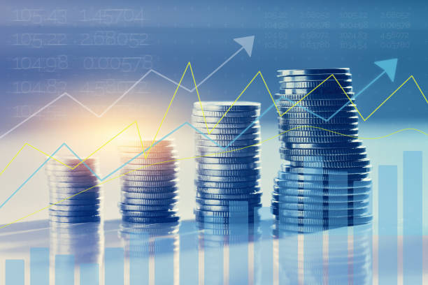 istock Coins in piles with investment appreciation chart 1363962675