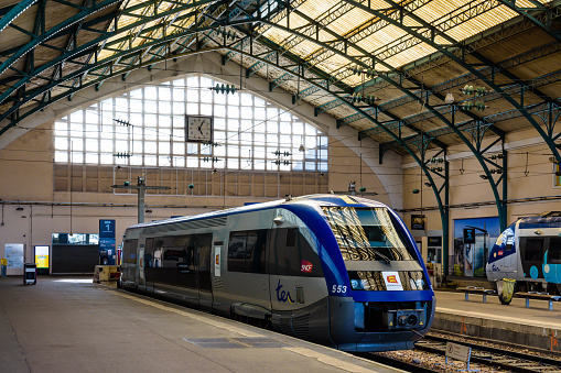 Le Havre, France - June 12, 2021: A TER intercity railcar (Alstom X73500) is stationing at the platform in the SNCF train station, under the glass hall built in 1882.