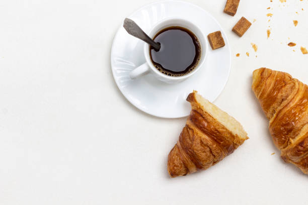 istock Two halves of croissant on table. 1363964593