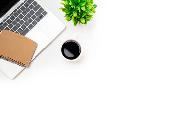 istock White office desk table with blank notebook, computer keyboard and other office supplies. Top view with copy space, flat lay. 1363964632