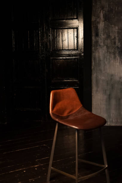 istock old leather chair in dark room 1363964661