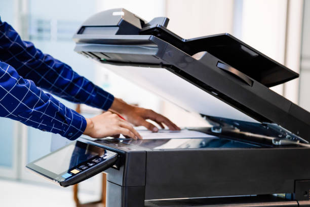 istock Businessmen press button on the panel for using photocopier or printer for printout and scanning document paper at office. 1363964667