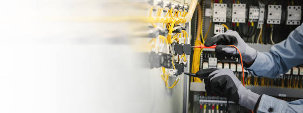 istock Electrical engineers test electrical installations and wiring on protective relays, measuring them with a multimeter. 1363965836