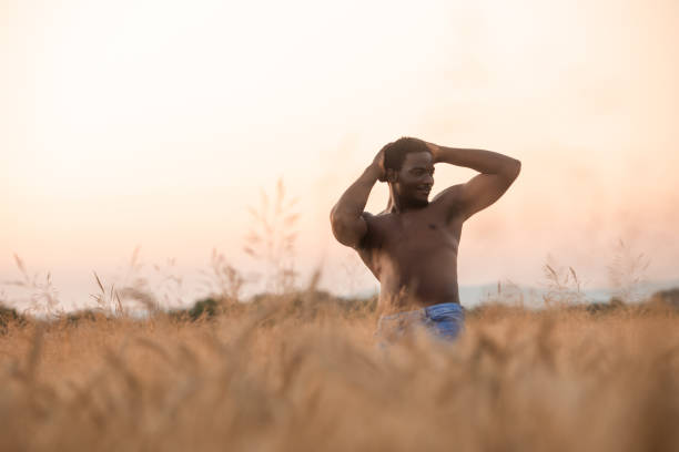istock Young Woman Standing On Field Against Sky During Sunset 1363967486