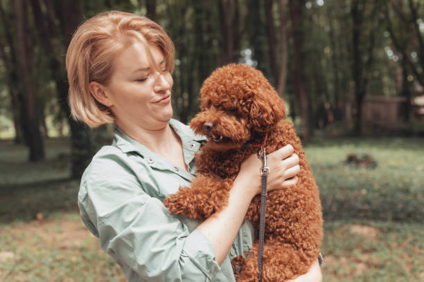 istock Side View Of Woman With Dog On Tree 1363967746