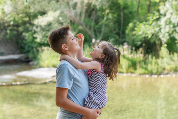 Portrait of happy brother and sister in nature