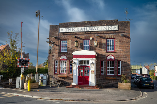 LONDON, UK, 8 November 2021: The Railway Inn, a traditional English pub located next to Billingshurst Railway Station. Many railway stations in the UK have pubs located next to them to offer refreshment to weary travellers.