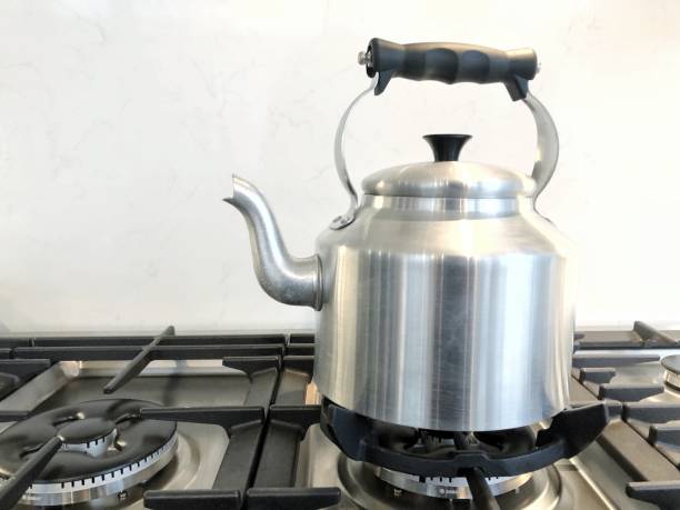 istock Old-fashioned kettle urn on a gas stove￼ 1363971264